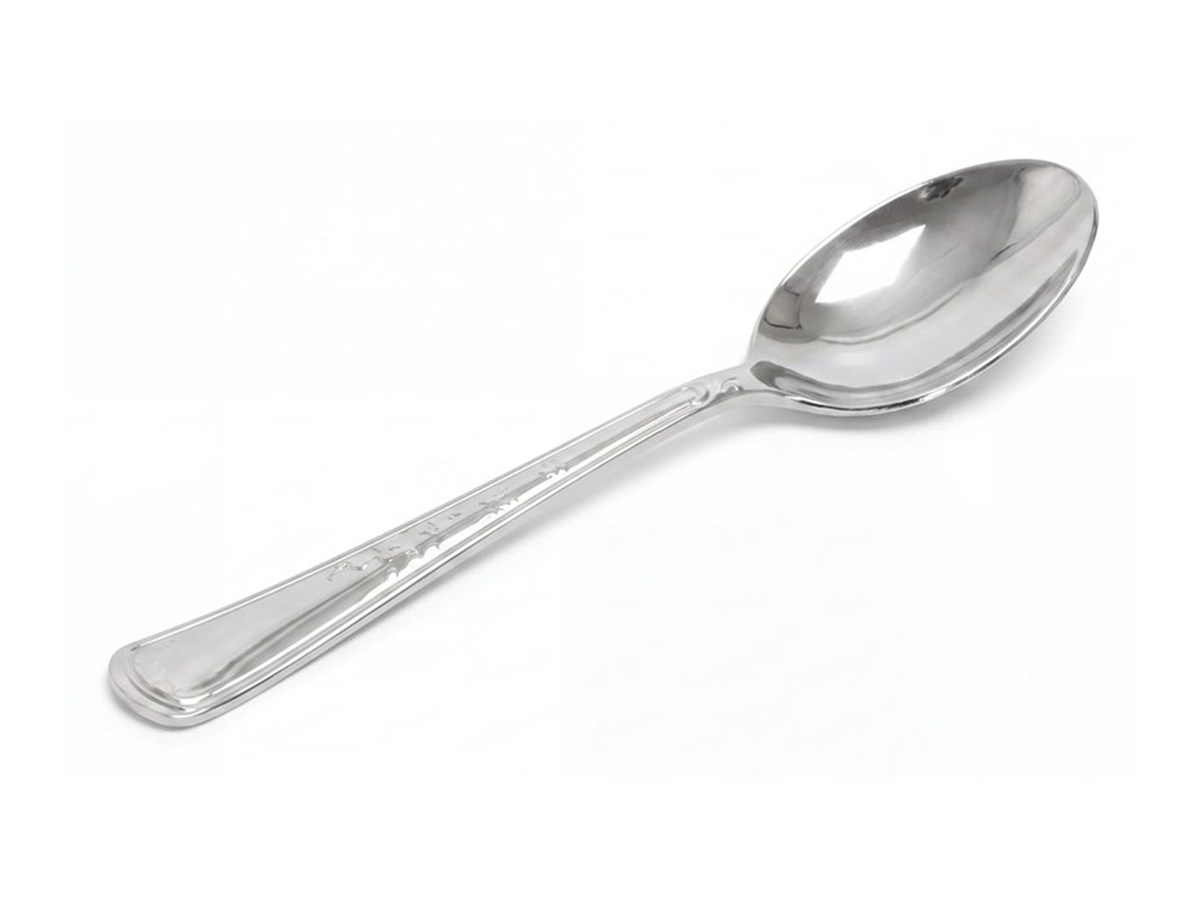 Silver disposable spoon on a white background